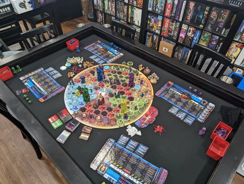 Cysmic table setup with faction boards, cards, and miniatures